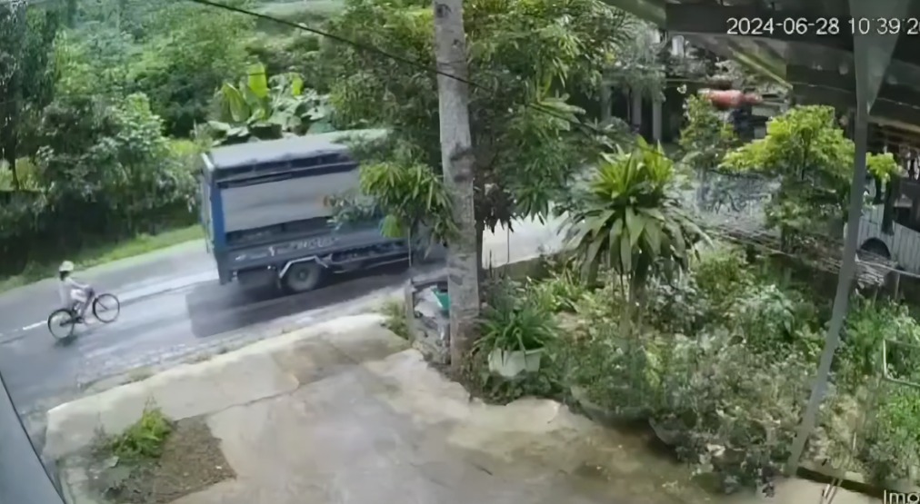 ciclista intenta rebasar camión de carga