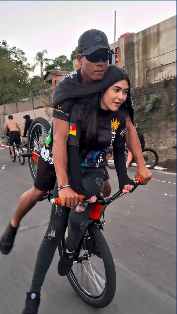 Joven hace caballito en bicicleta y tira a su novia